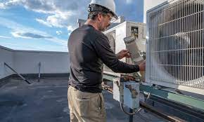 Technician cleaning dryer vent with specialized tools